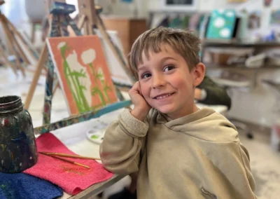 student shows off his artwork