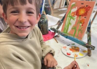 student smiles with his work