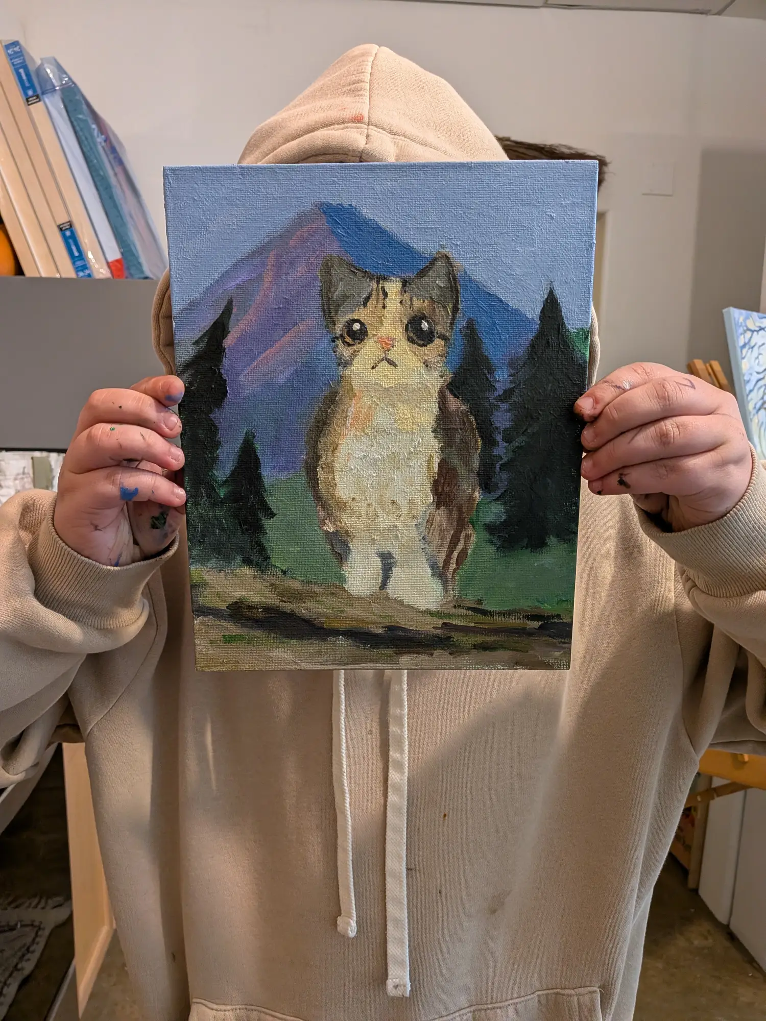 student shows painting of cat