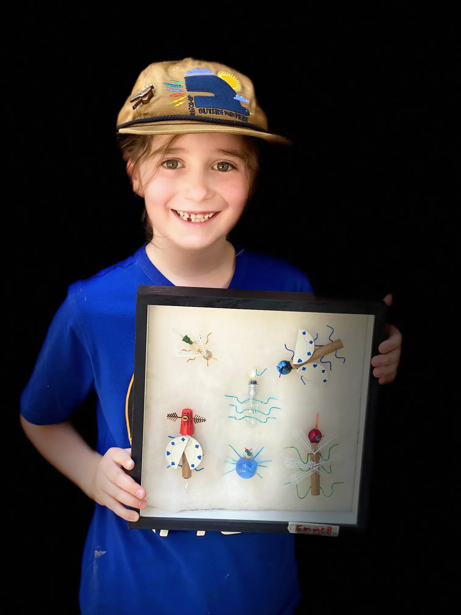 student shows off his arts and crafts