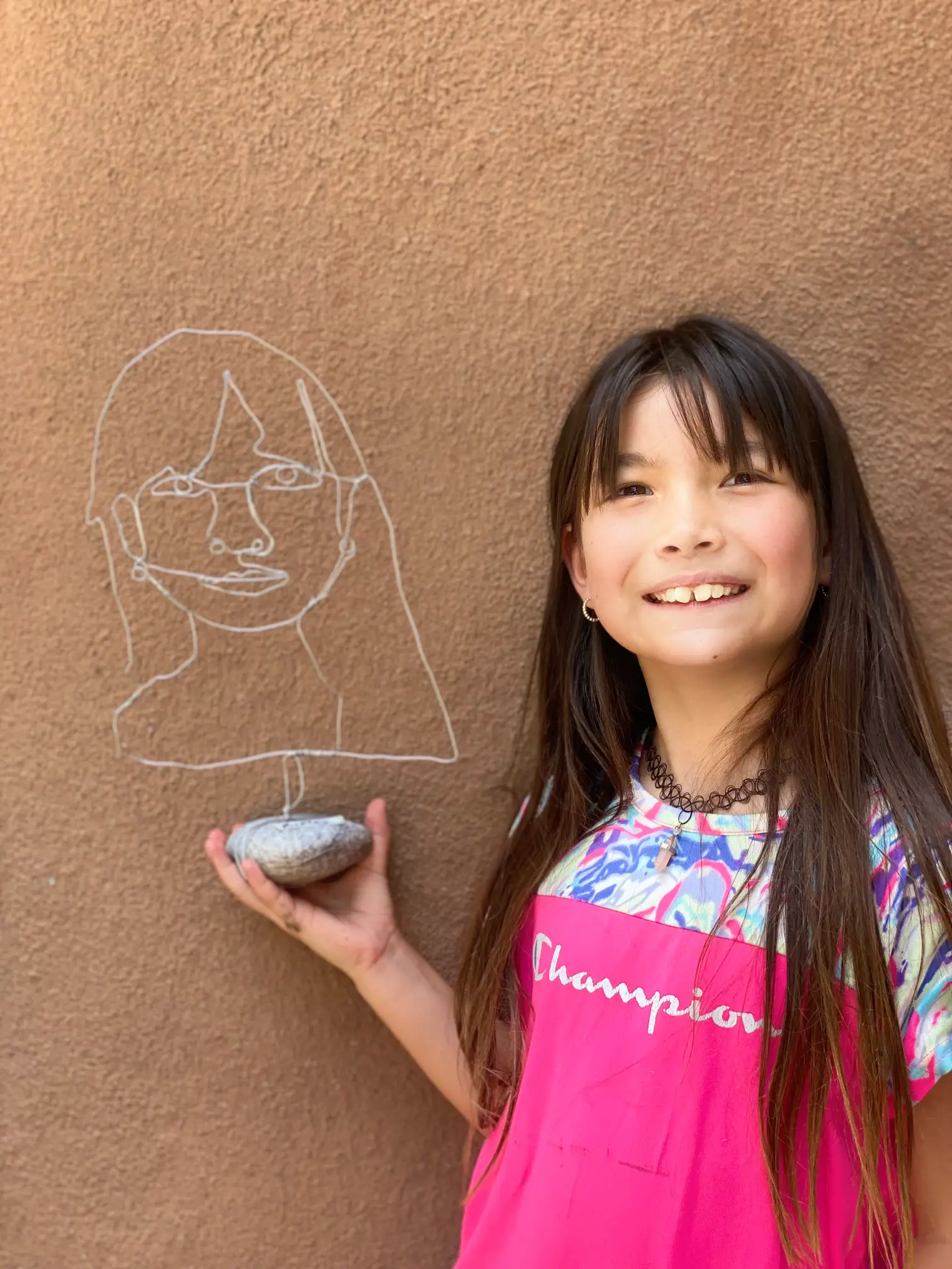 student drawing with chalk